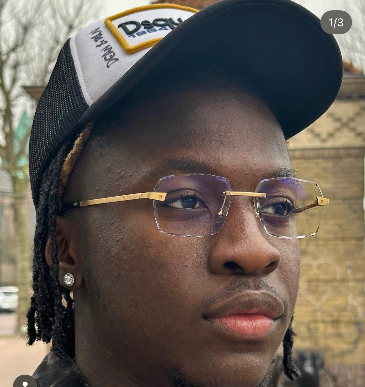 A customer wearing gold rimless glasses with custom faceted lenses